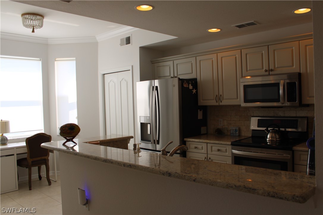 a kitchen with stainless steel appliances a refrigerator and a stove top oven