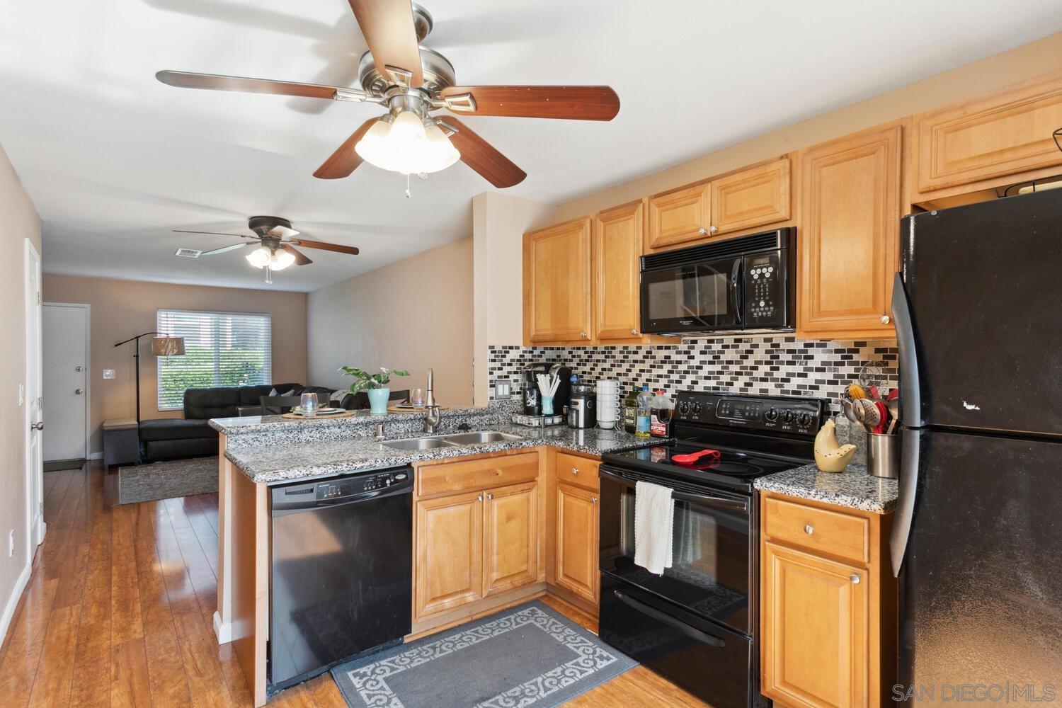 a kitchen with stainless steel appliances granite countertop a stove sink and cabinets