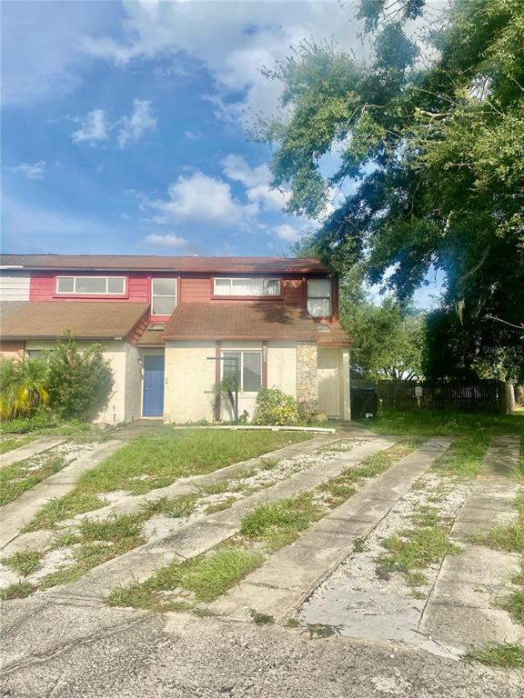 a view of a house with a yard and garage