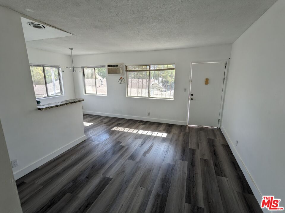 a view of wooden floor and windows in a room