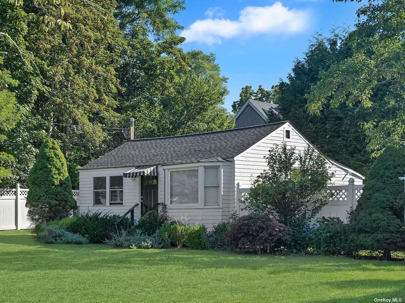 a view of a house with a yard and a garden