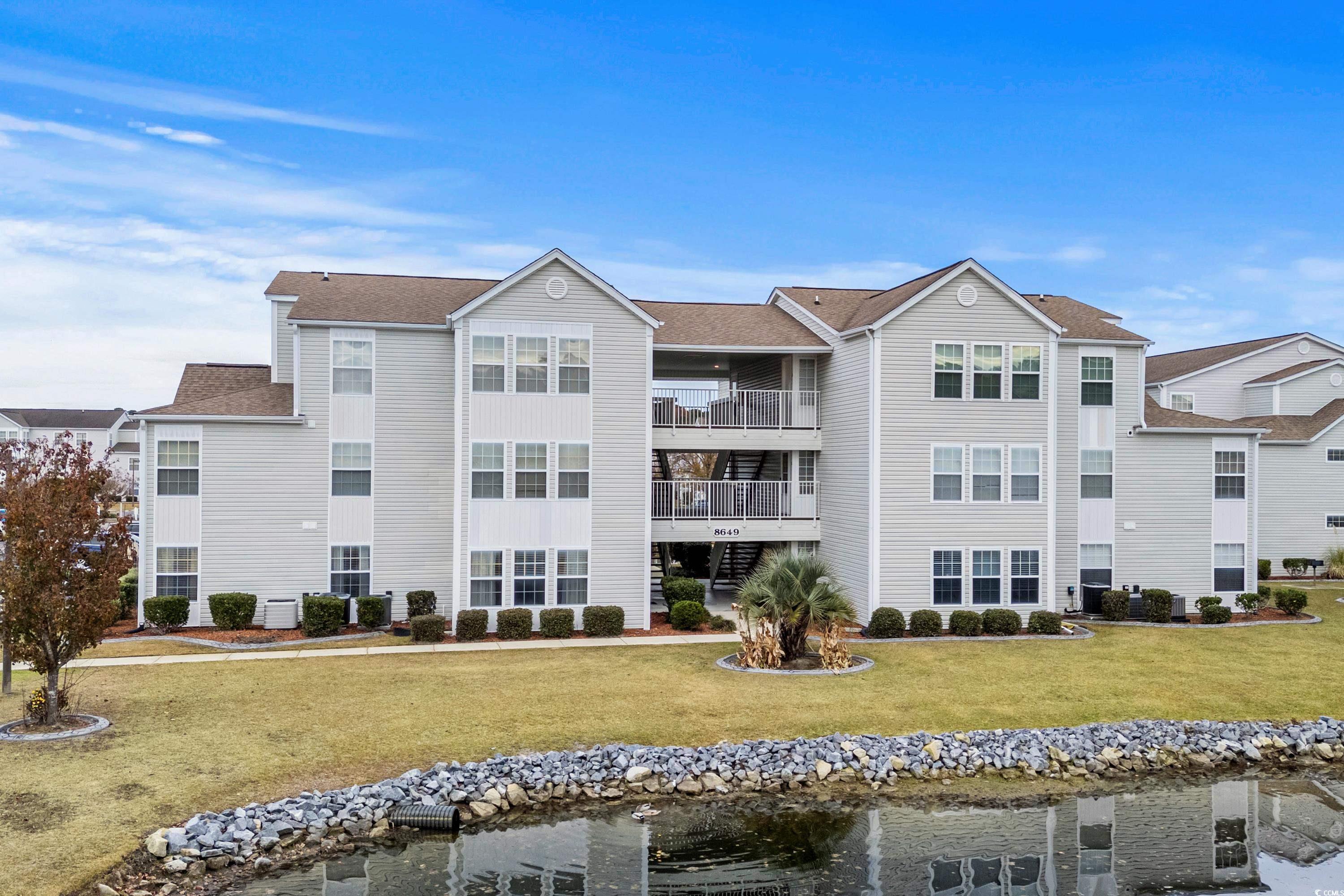 View of building exterior featuring a water view a