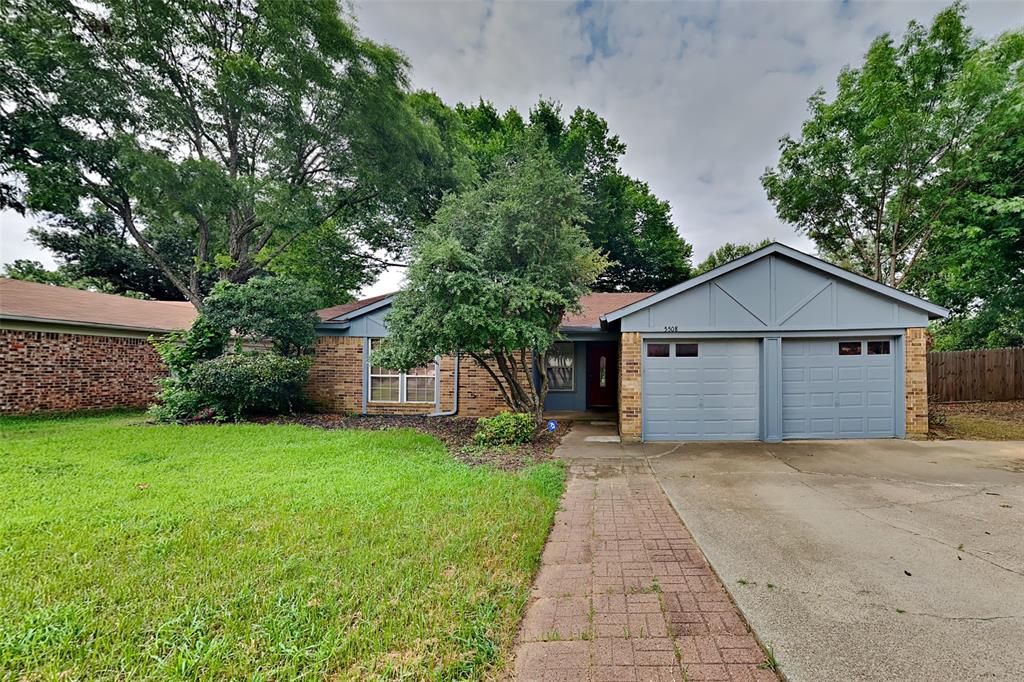 a front view of house with yard and trees