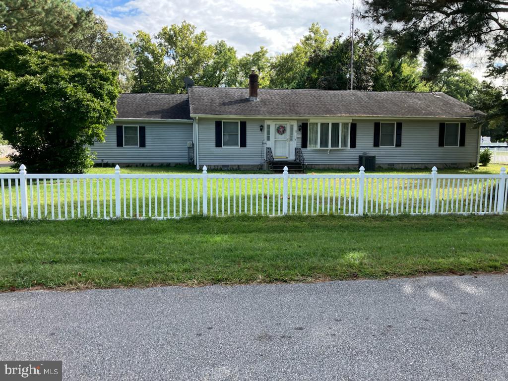 a front view of a house with a garden and deck