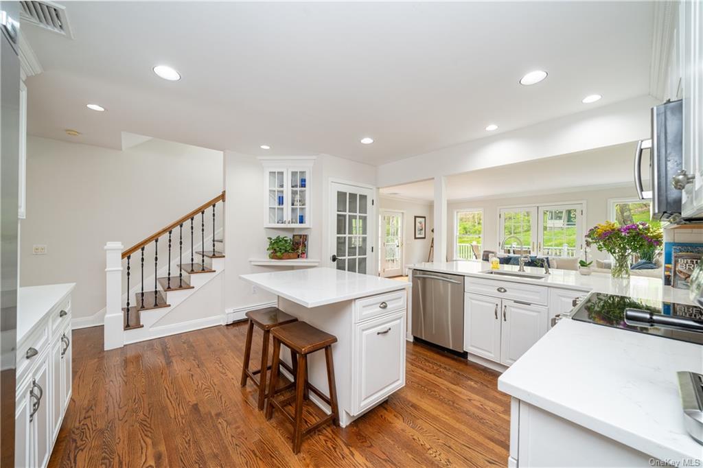 a kitchen with sink stove and cabinets