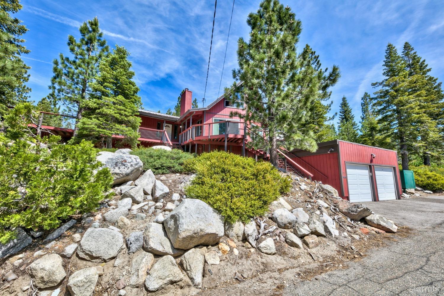 Boulder studded lot with two car garage