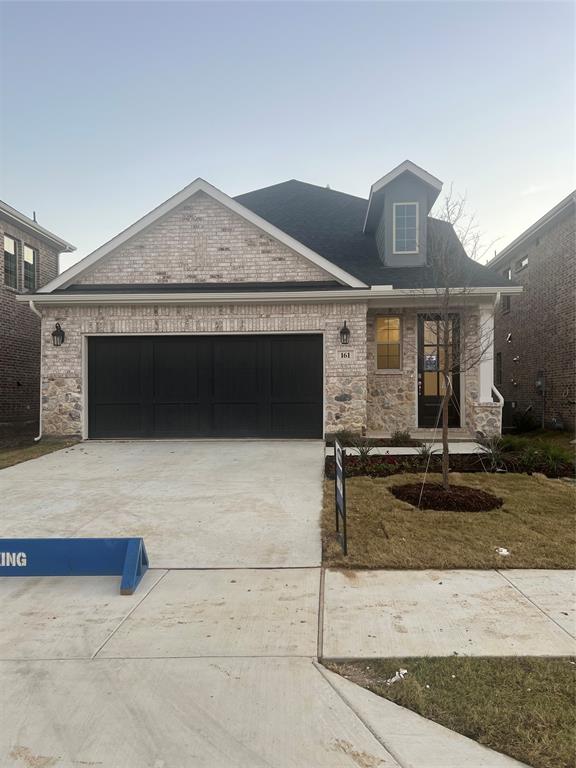 a front view of a house with garage