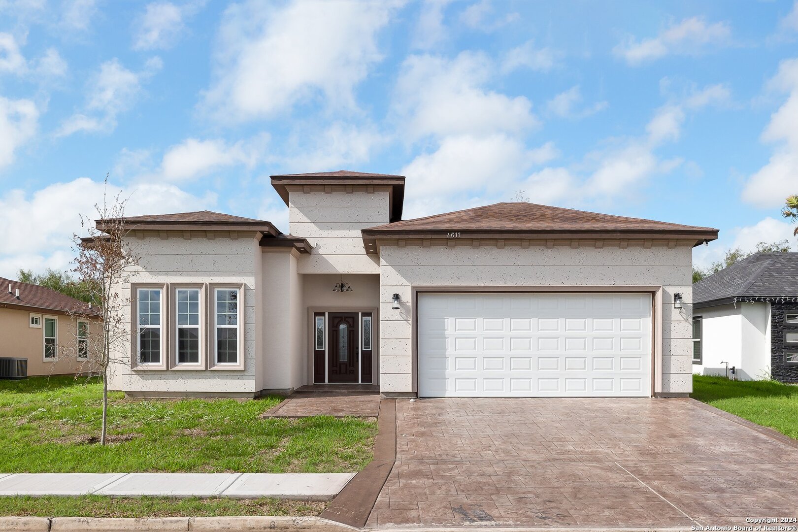 a front view of a house with a yard