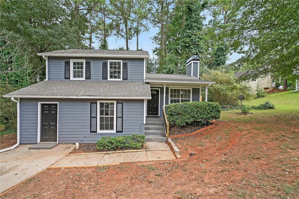 a front view of a house with a garden