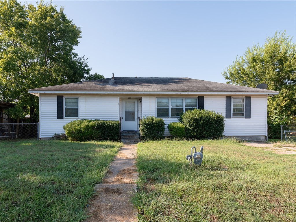 a front view of house with yard and green space