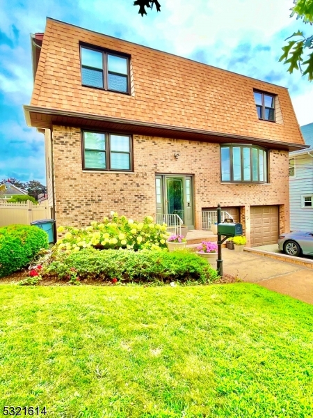 a view of a house with a yard and plants