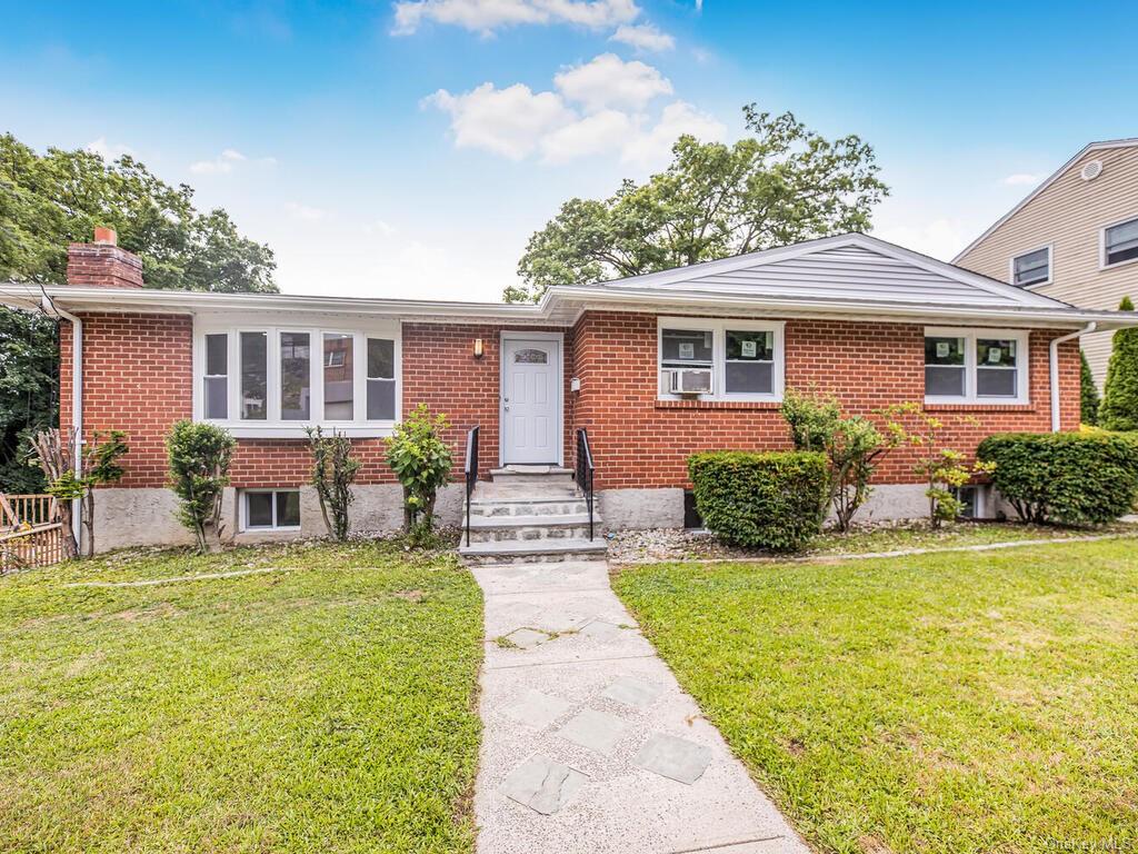 Single story home featuring a front yard