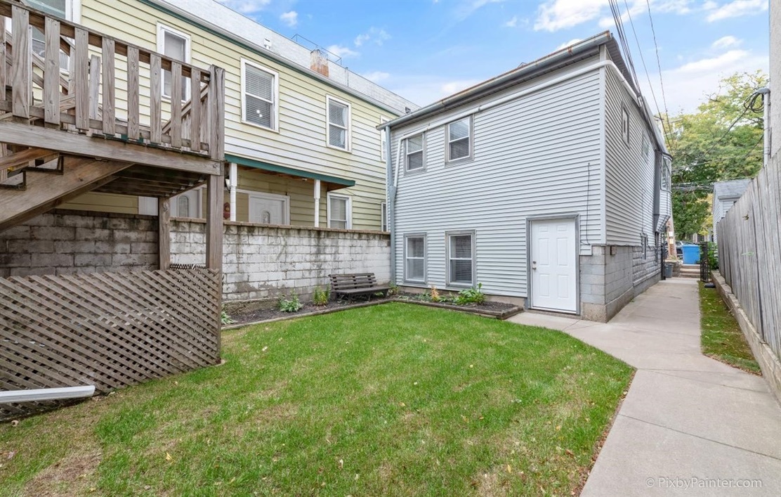 a view of a house with a backyard