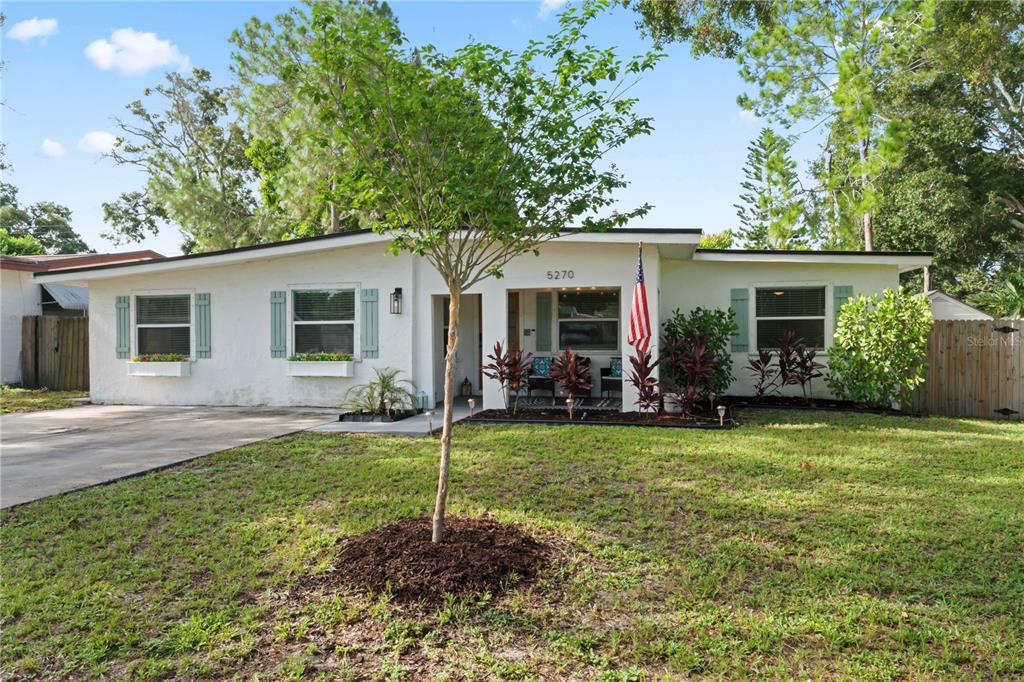 a view of a house with a backyard