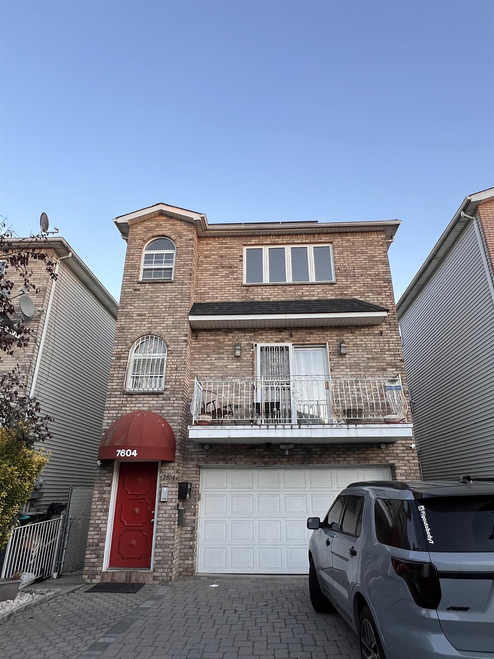 a front view of a house with parking space