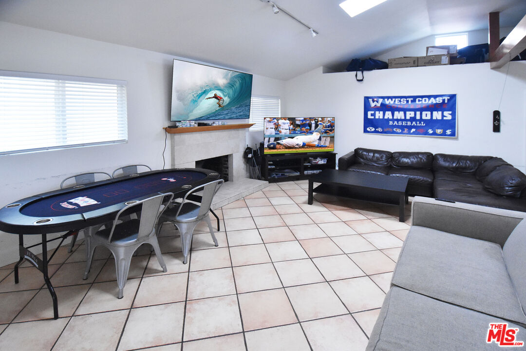 a living room with furniture a flat screen tv and a table