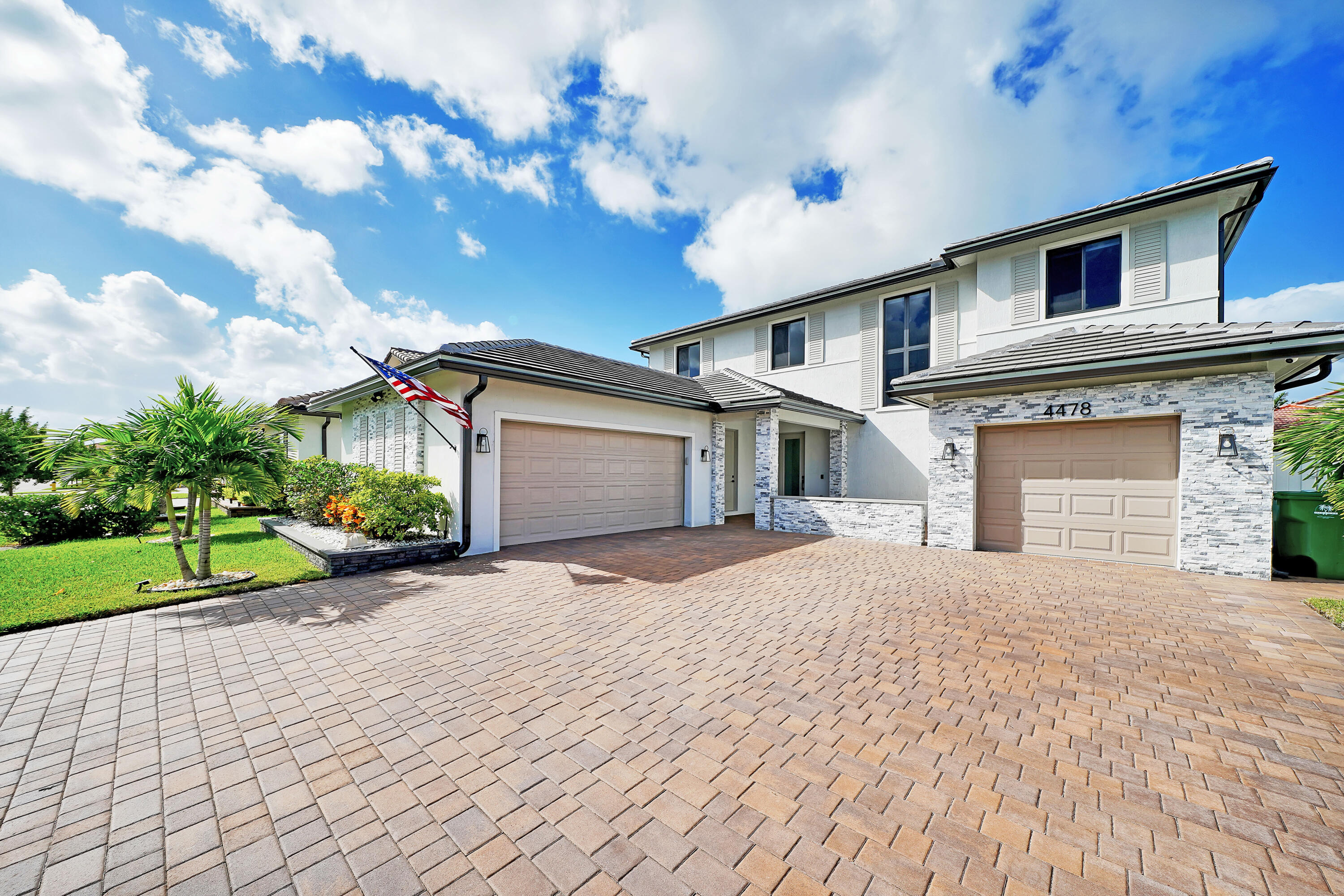 a front view of a house with a yard and a garage