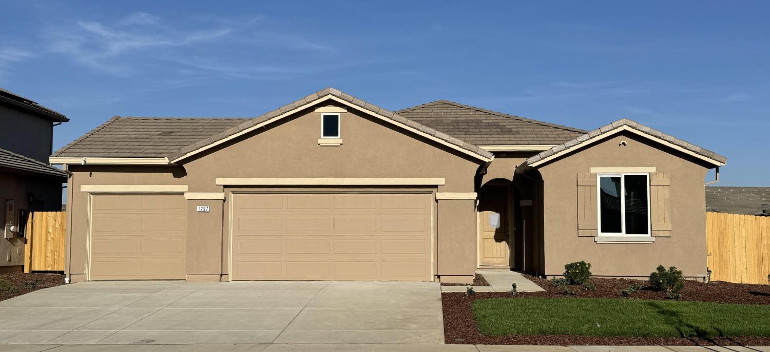 a front view of a house with garage