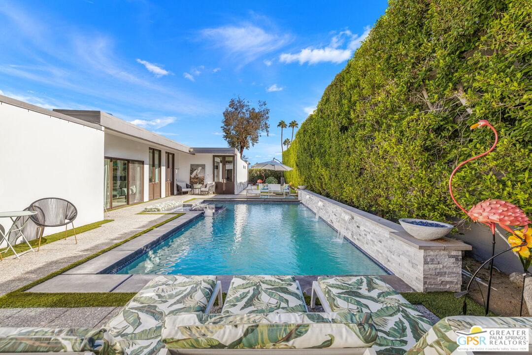 a view of a swimming pool with a lounge chairs