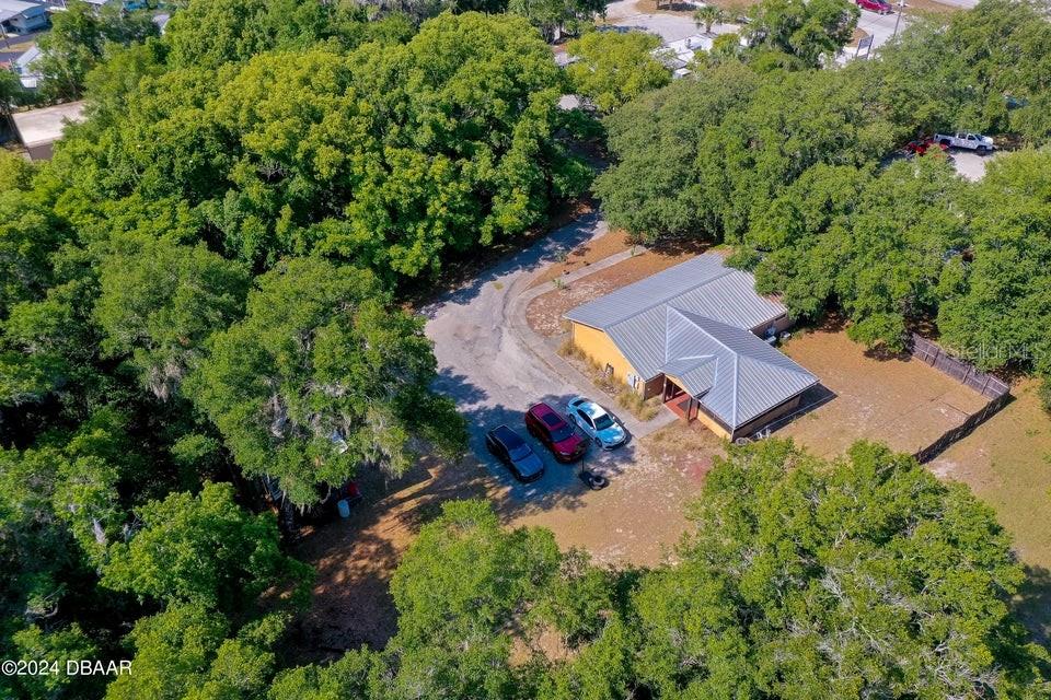 an aerial view of a house with a yard