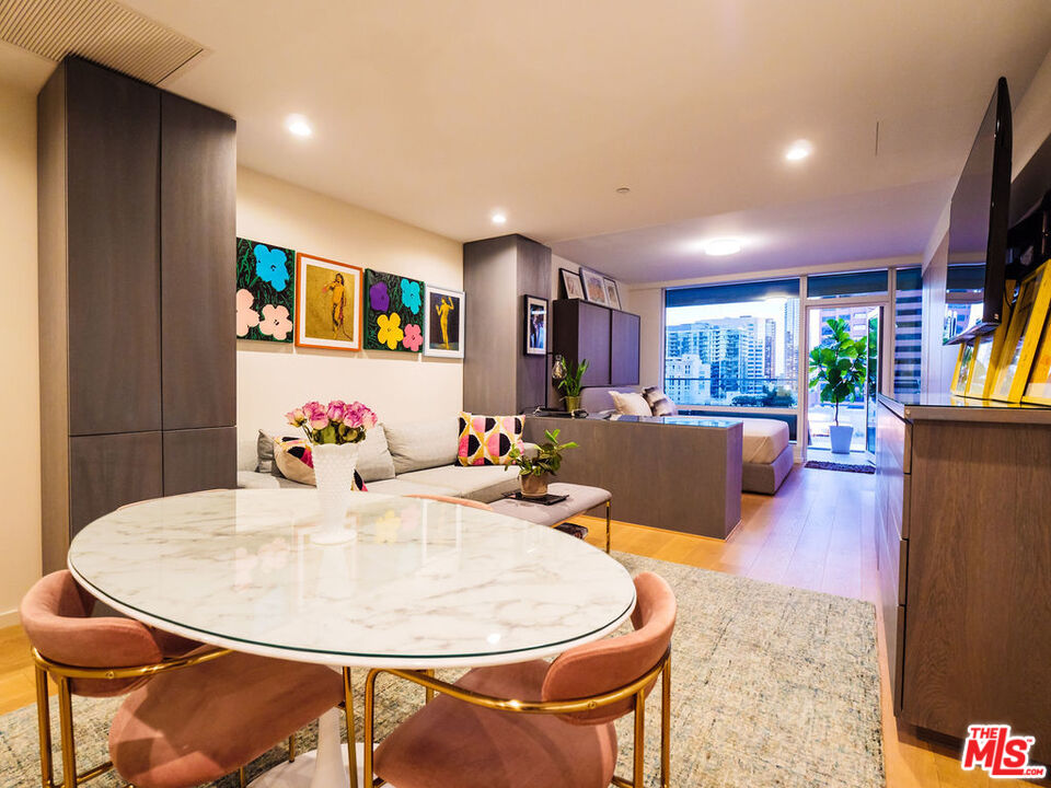 a living room with dining room and wooden floor