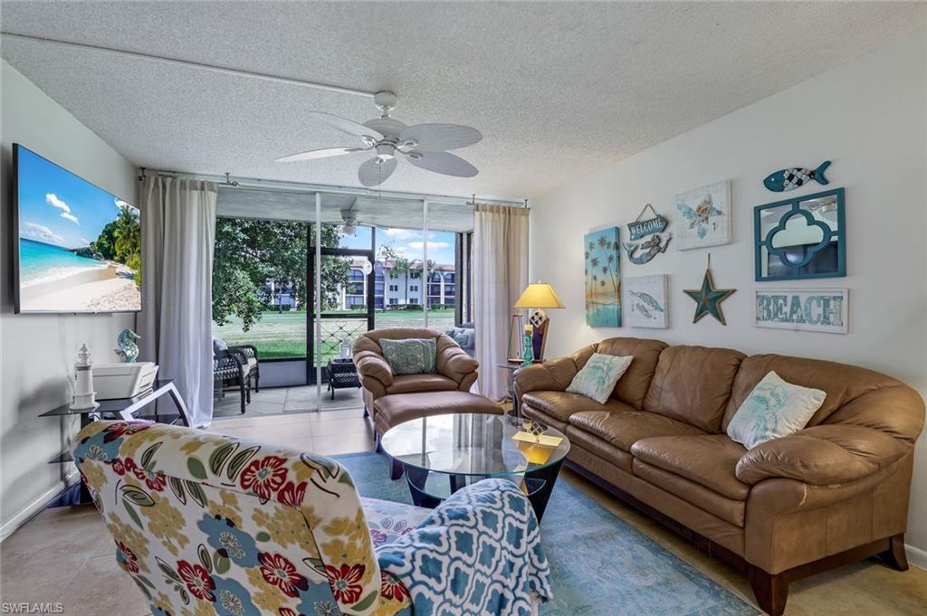 a view of living room filled with furniture and a large window