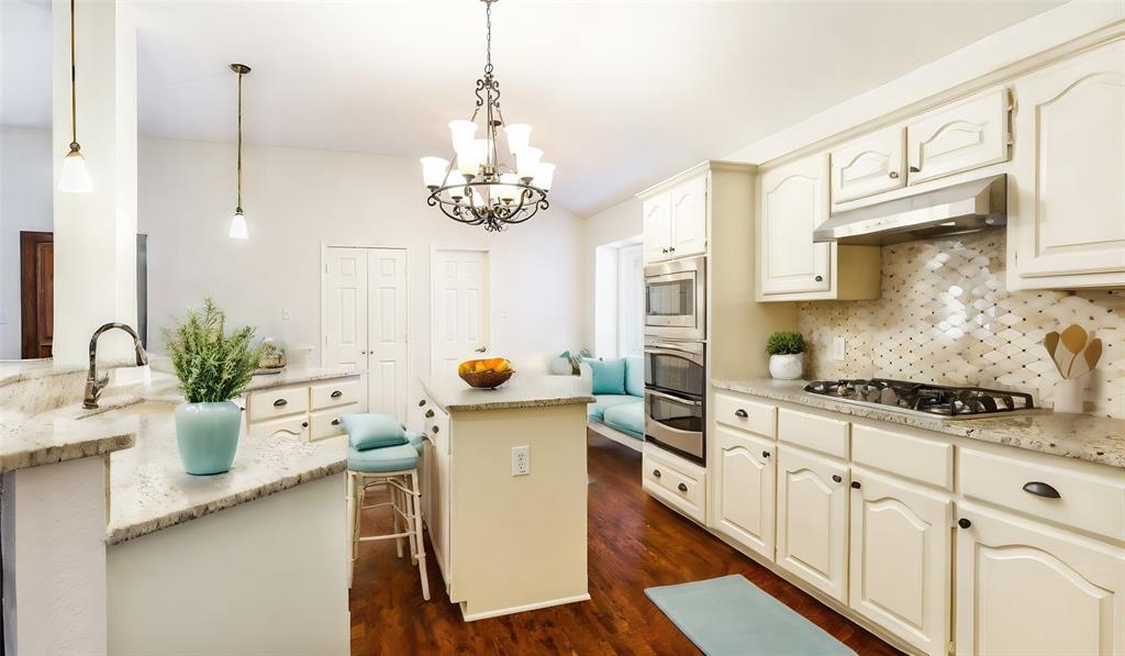 a kitchen with sink a stove and cabinets