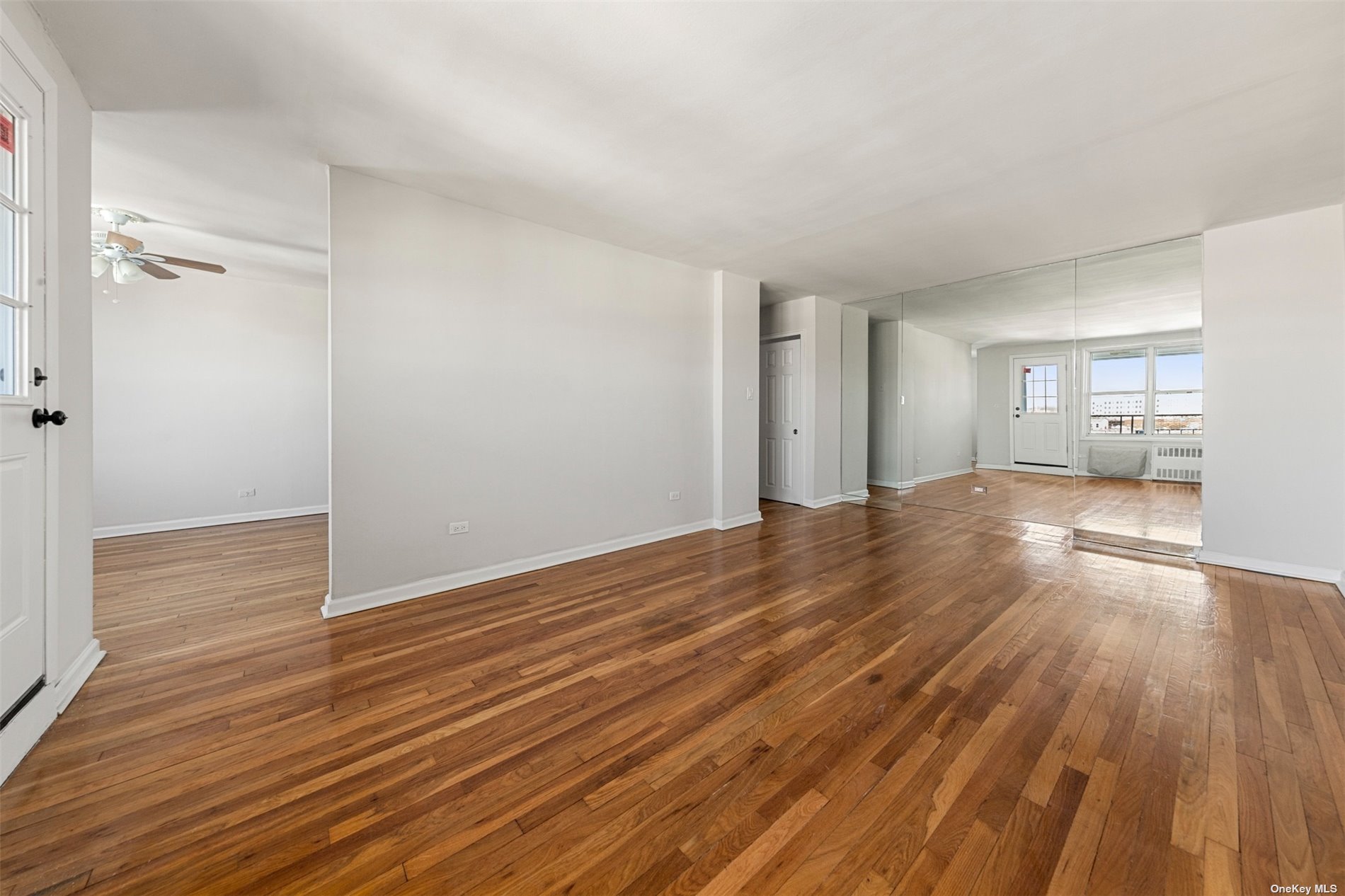 a view of a room with wooden floor and a sink