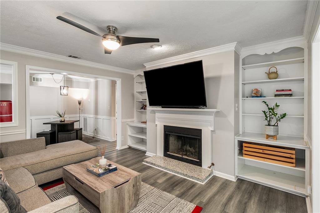 a living room with furniture a fireplace and a flat screen tv