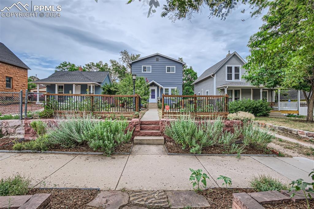 a front view of a house with garden