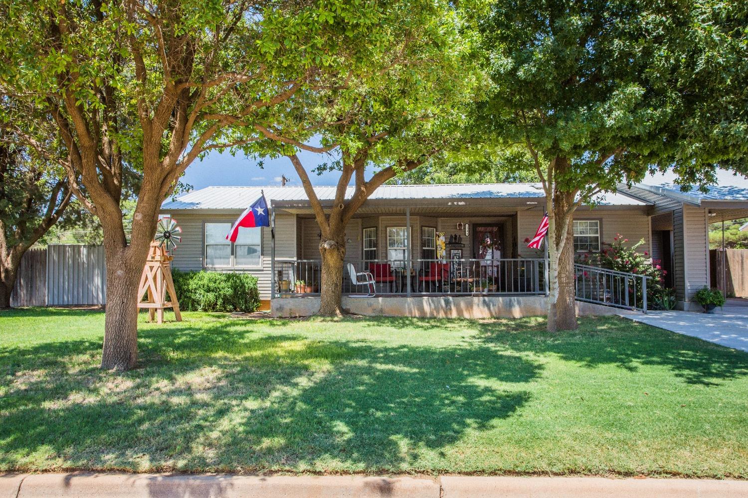 a view of a house with a yard porch and sitting area