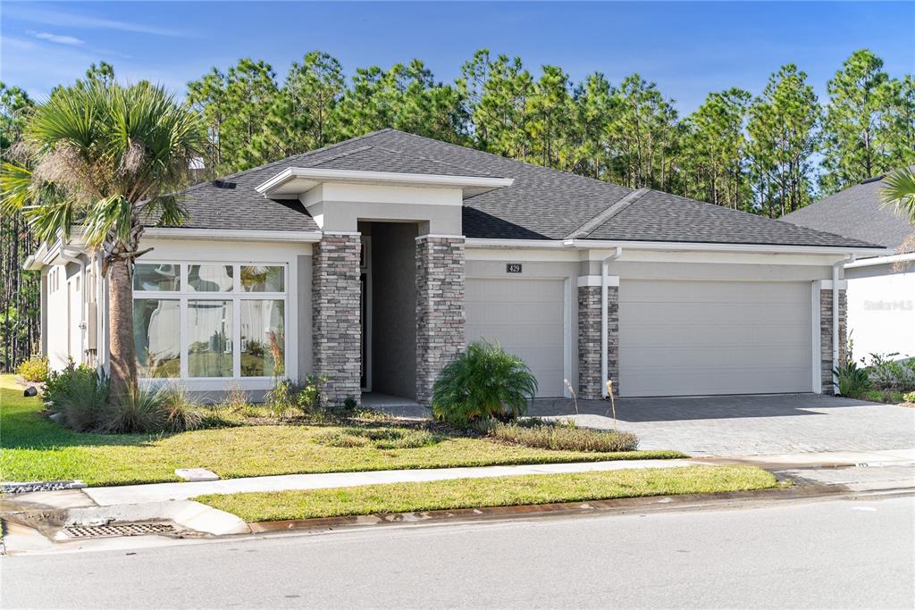 a front view of a house with a yard