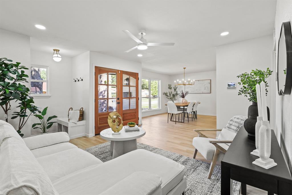 a living room with furniture and flowers