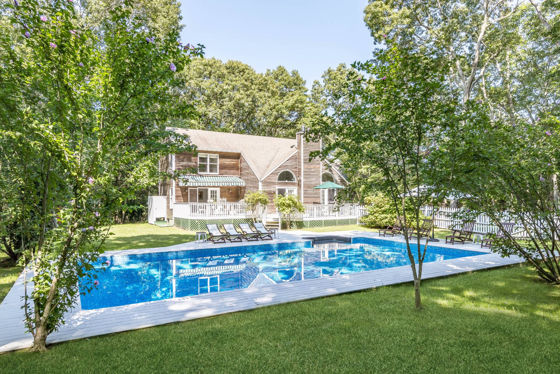 a view of a house with a yard and sitting area