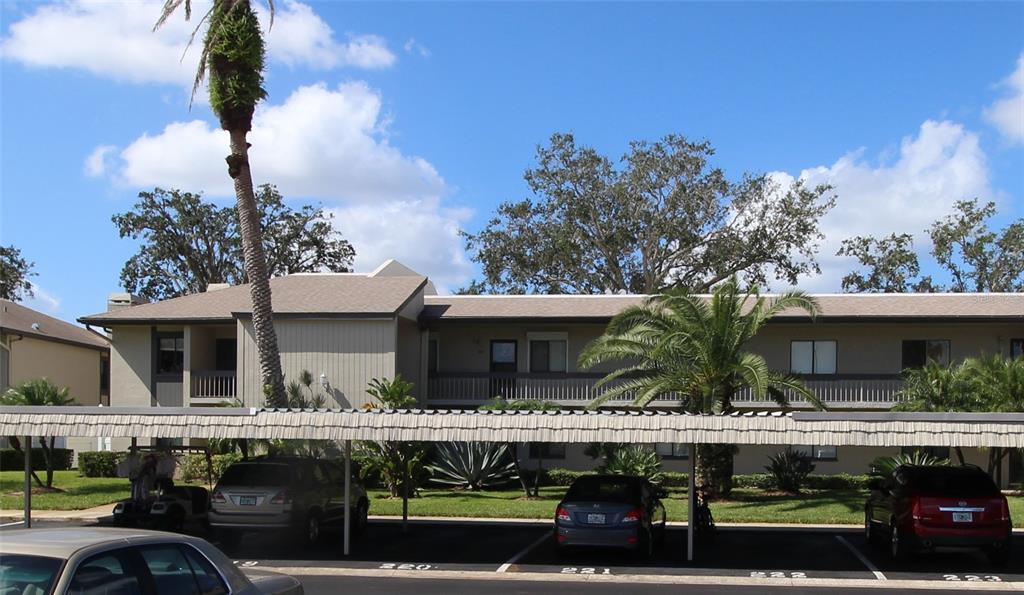 a view of house with outdoor space and car parked