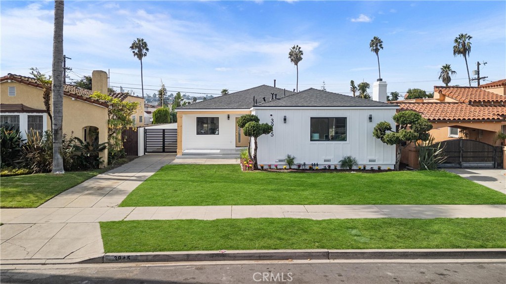 a view of a house with a yard and plants