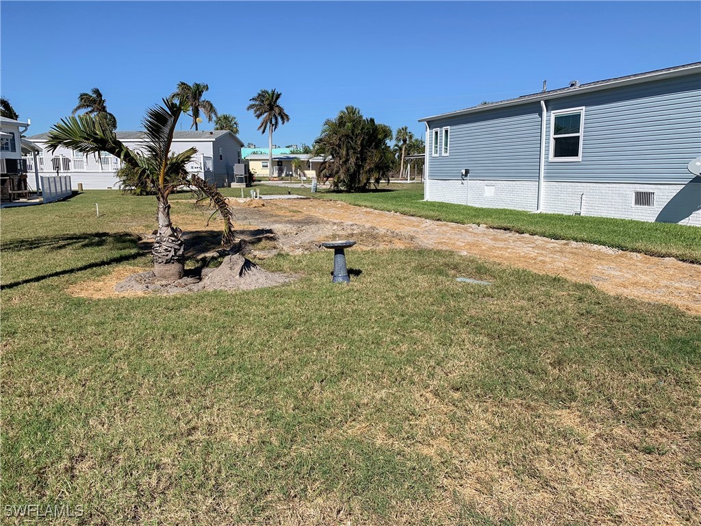 a view of a house with backyard and sitting area