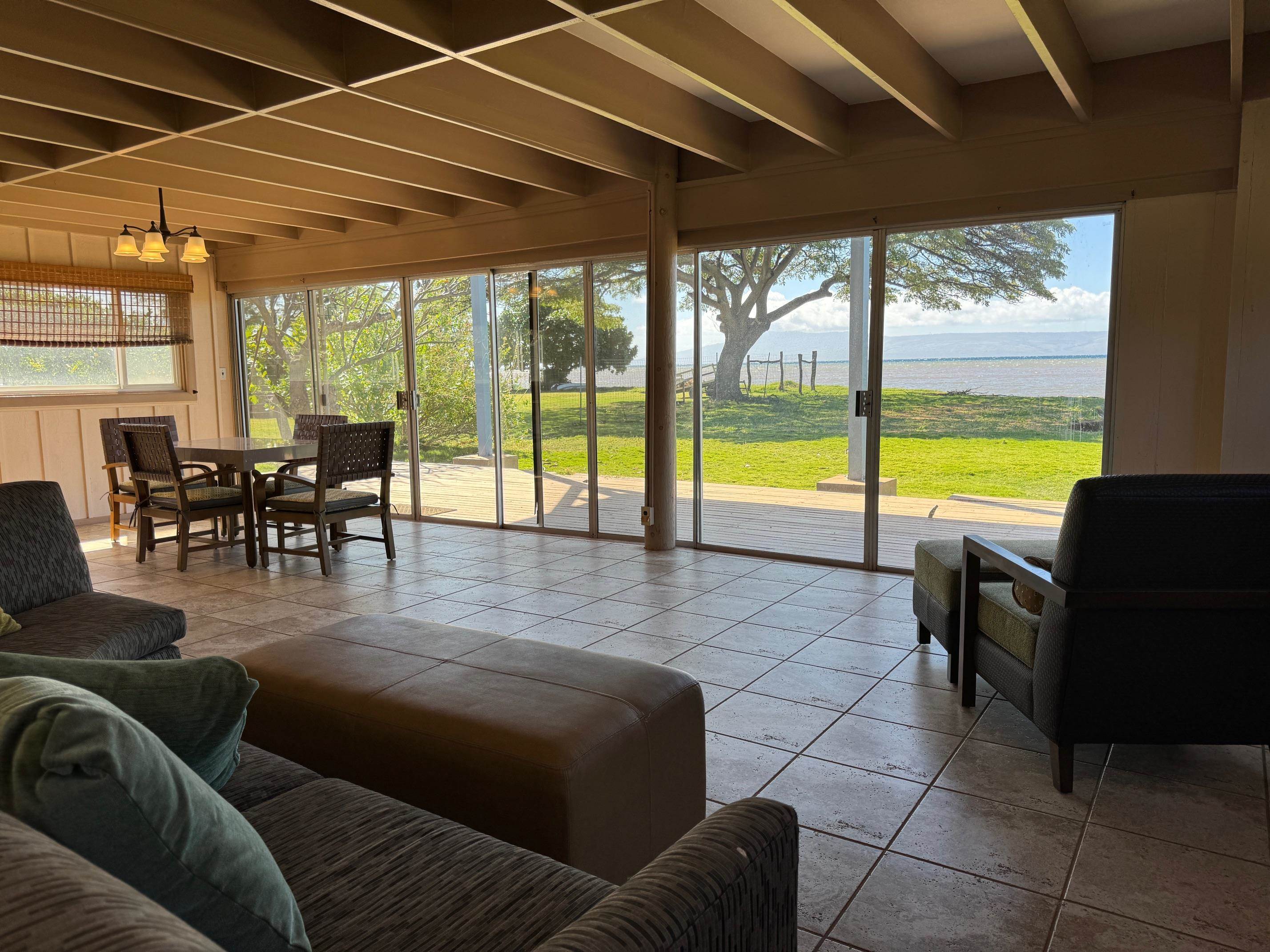 a living room with furniture and floor to ceiling windows