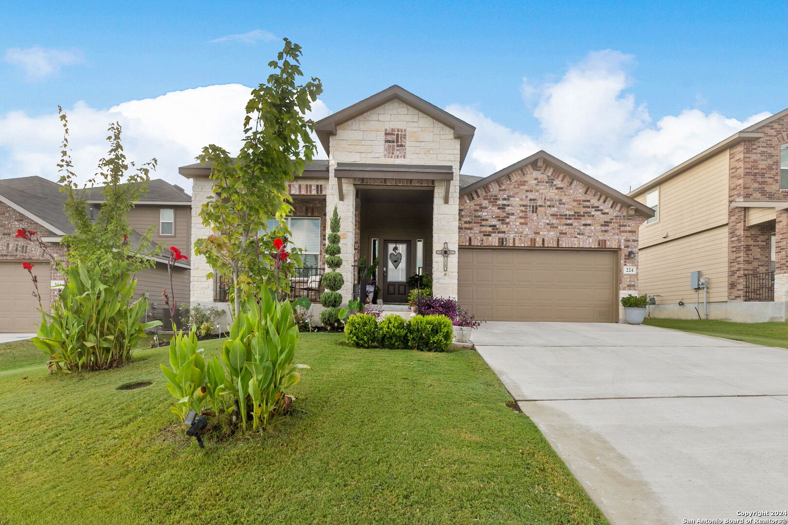 a front view of a house with a garden