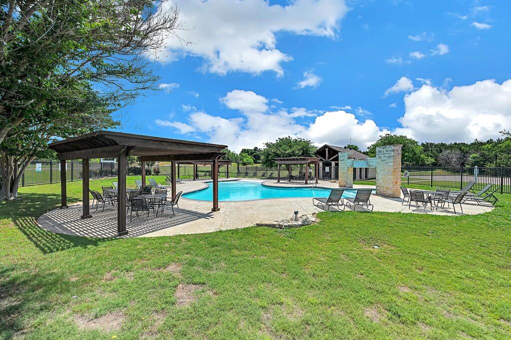 a view of a house with swimming pool and sitting area