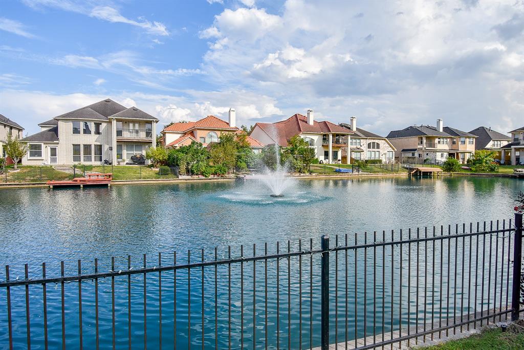 The backyard boasts a stunning view of the lake, where shimmering waters stretch out under the sun. A gentle breeze carries the scent of water and earth, enhancing the ultimate relaxation experience in this picturesque setting.