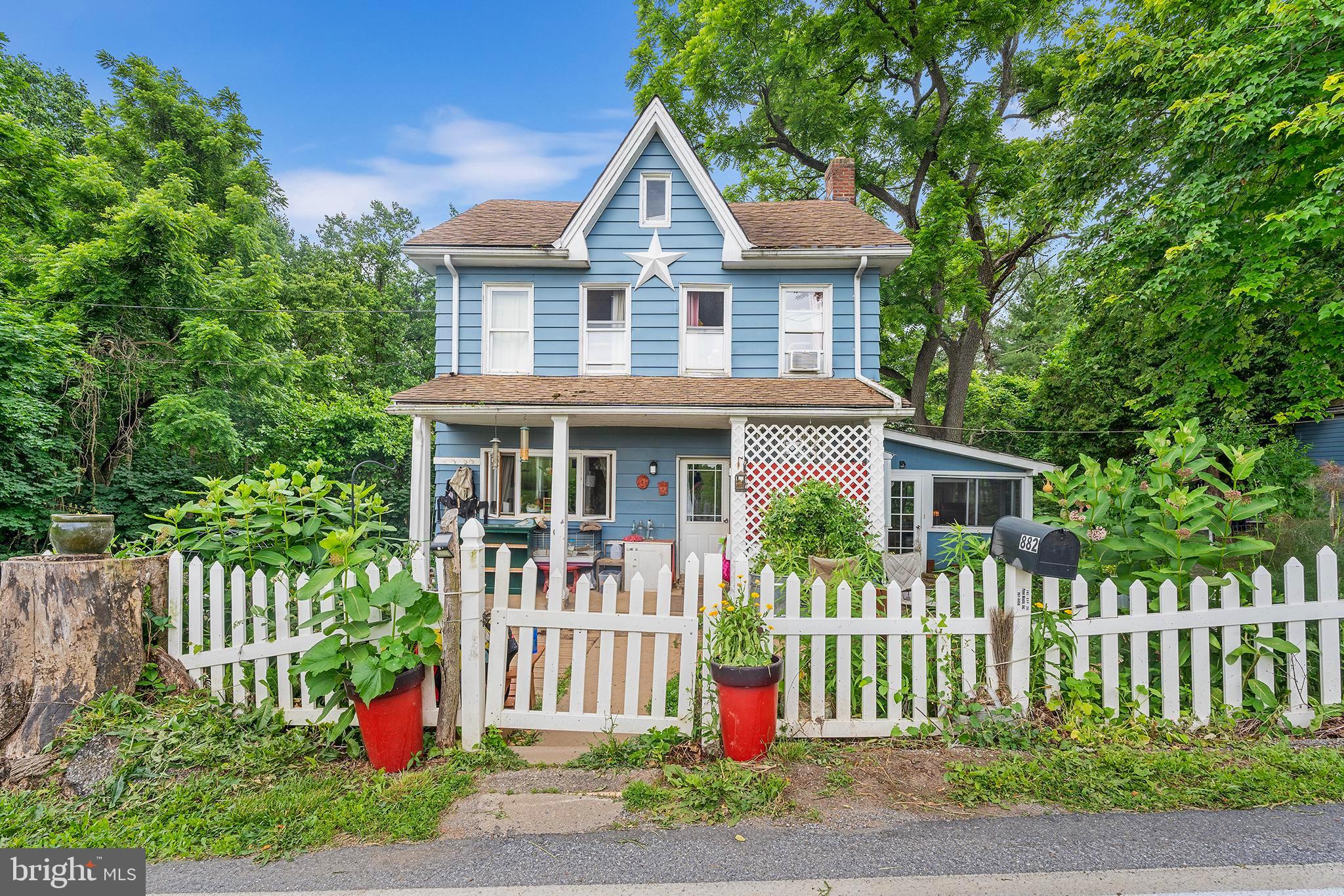 a front view of a house with a garden and plants