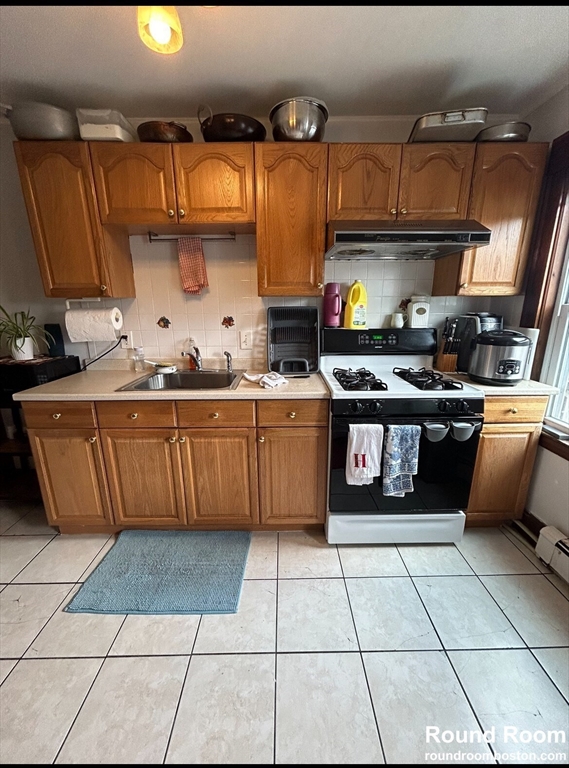 a kitchen with stainless steel appliances a stove a sink and a counter