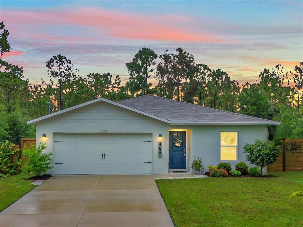 a front view of a house with a yard and garage