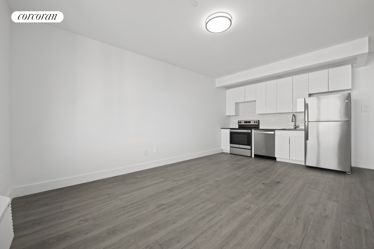 a view of kitchen with wooden floor and electronic appliances