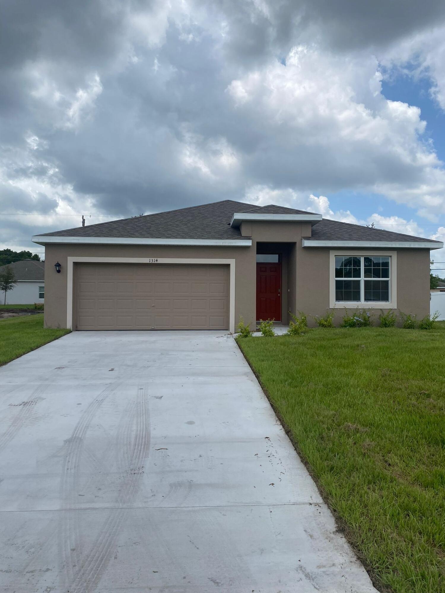 a front view of house with yard and green space