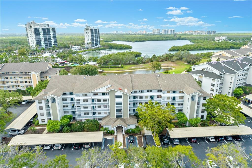 a aerial view of a city with lots of residential buildings lake and ocean view