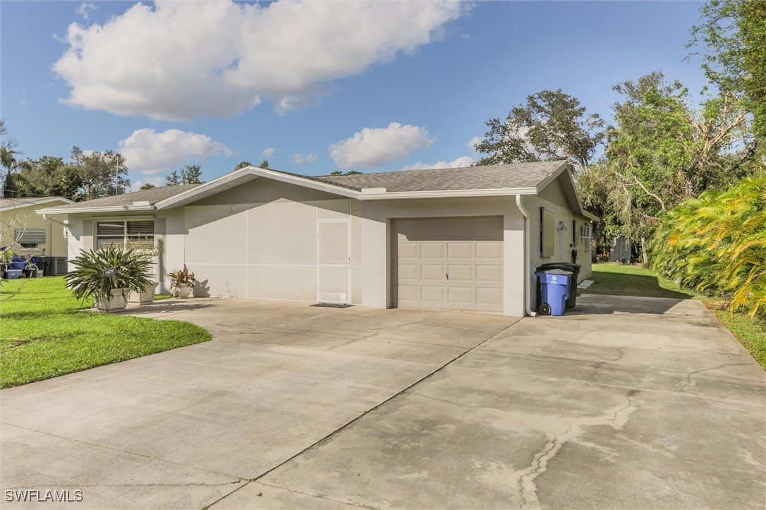 a view of a house with a yard and garage