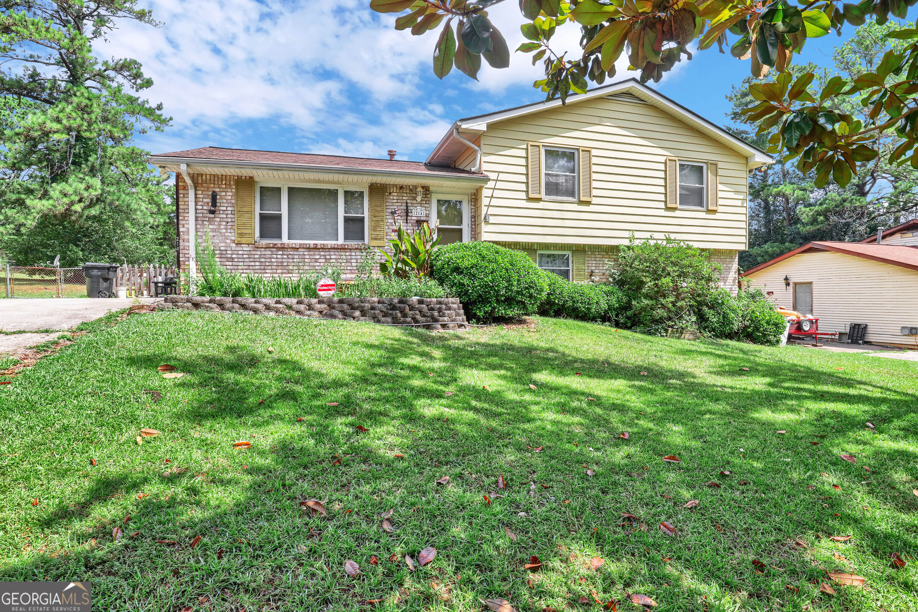 a front view of house with yard and green space