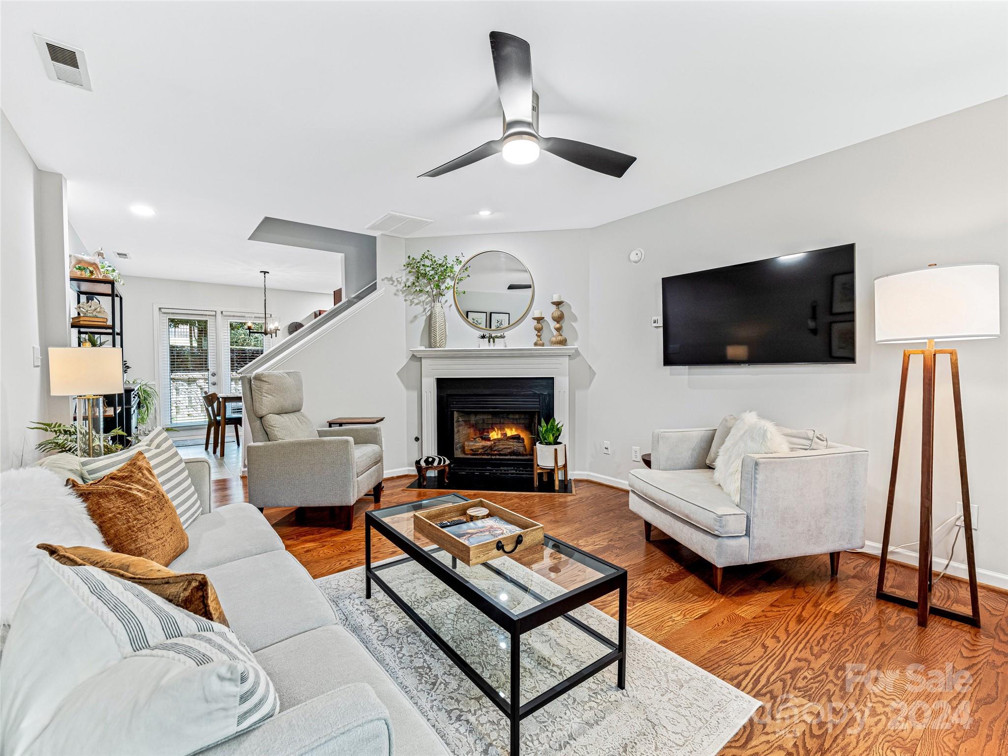 a living room with furniture a rug and a flat screen tv